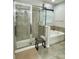 Bathroom featuring a glass enclosed shower, soaking tub, and ceramic tile at 4241 Sw 62Nd Loop, Ocala, FL 34474