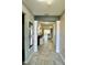 Bright, spacious hallway leads to living area with tiled floors and contemporary decor at 4241 Sw 62Nd Loop, Ocala, FL 34474