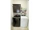Well-lit laundry room featuring modern washer and dryer, with upper cabinets and open shelving at 4241 Sw 62Nd Loop, Ocala, FL 34474