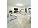 Bright living room features tile flooring, a modern fireplace, and a large-screen television at 4241 Sw 62Nd Loop, Ocala, FL 34474