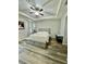 Relaxing main bedroom features a tray ceiling, wood-look flooring, and a built-in bench at 4241 Sw 62Nd Loop, Ocala, FL 34474