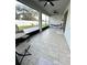 Spacious screened lanai with tile flooring, ceiling fans, and comfortable seating; view of fenced backyard at 4241 Sw 62Nd Loop, Ocala, FL 34474