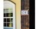 Close up of address number '4301' on a wooden beam next to a window at 4301 Se 6 Ave, Ocala, FL 34480