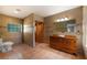 Bathroom with a glass-enclosed shower, tile flooring, and wooden vanity with a white sink at 4301 Se 6 Ave, Ocala, FL 34480