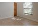 Bright, empty bedroom with tiled floor, large window, and light filtering through the blinds at 4301 Se 6 Ave, Ocala, FL 34480