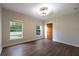 An empty bedroom with wood floors and two windows providing lots of natural light at 4301 Se 6 Ave, Ocala, FL 34480