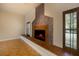 Tiled fireplace with a stone mantle and hearth, next to a window with light streaming in at 4301 Se 6 Ave, Ocala, FL 34480