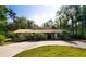 Charming single-story home featuring a red tiled roof, circular driveway, and mature landscaping at 4301 Se 6 Ave, Ocala, FL 34480