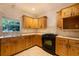 Kitchen boasts wood cabinetry, tile backsplash and stainless appliances at 4301 Se 6 Ave, Ocala, FL 34480