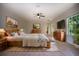 Spacious main bedroom with a ceiling fan, wooden furniture, and plenty of natural light from the window at 4301 Se 6 Ave, Ocala, FL 34480