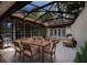 Relaxing screened patio features an outdoor dining set, grill, and plenty of room for entertaining at 4301 Se 6 Ave, Ocala, FL 34480