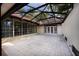 Spacious screened patio with tile flooring, glass wall, and double door access to the home's interior at 4301 Se 6 Ave, Ocala, FL 34480