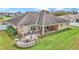 Large backyard featuring a built-in firepit with seating and covered patio, perfect for outdoor entertaining at 4839 Sw 63Rd St, Ocala, FL 34474