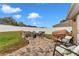 A great outdoor patio featuring a brick fire pit with chairs and a covered grill, perfect for entertaining guests at 4839 Sw 63Rd St, Ocala, FL 34474