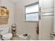 Bathroom with a toilet, white vanity, and built-in shelving for storage at 4839 Sw 63Rd St, Ocala, FL 34474