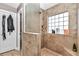 The bathroom with a glass-enclosed shower and tan tiled walls at 4839 Sw 63Rd St, Ocala, FL 34474