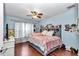 Bright bedroom with hardwood floors, a ceiling fan, and a queen-sized bed at 4839 Sw 63Rd St, Ocala, FL 34474