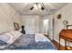 Bedroom featuring hardwood floors, a ceiling fan, and a comfortable queen-sized bed at 4839 Sw 63Rd St, Ocala, FL 34474