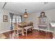 Cozy dining area with a rustic table, cushioned seating, and stylish cabinet at 4839 Sw 63Rd St, Ocala, FL 34474