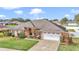Beautiful exterior view of a home featuring well-manicured lawn, attached garage, and elegant landscaping at 4839 Sw 63Rd St, Ocala, FL 34474