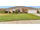 Attractive single-level home showcases a manicured lawn, an attached garage, and welcoming front entrance at 4839 Sw 63Rd St, Ocala, FL 34474