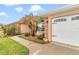 Side view of home with an attached garage, manicured landscaping with beautiful palm trees at 4839 Sw 63Rd St, Ocala, FL 34474