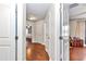 View of a brightly lit hallway with hardwood floors and access to other rooms at 4839 Sw 63Rd St, Ocala, FL 34474