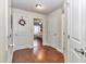 Hallway leading to a bedroom with hardwood floors and white doors at 4839 Sw 63Rd St, Ocala, FL 34474