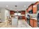 Well-lit kitchen featuring cherry wood cabinets, stainless steel appliances, and a center island with seating at 4839 Sw 63Rd St, Ocala, FL 34474