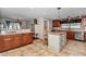 Spacious kitchen with wooden cabinets, granite countertops, and an island with breakfast bar at 4839 Sw 63Rd St, Ocala, FL 34474