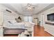 Bright main bedroom featuring a ceiling fan, hardwood floors, and white dressers at 4839 Sw 63Rd St, Ocala, FL 34474