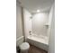 Bathroom features a bathtub and tiled surround at 5646 Sw 129Th Place Rd, Ocala, FL 34473