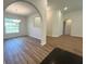 Bright dining room featuring hardwood floors, chandelier, and an arched entrance to the living room at 5646 Sw 129Th Place Rd, Ocala, FL 34473