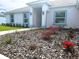 Close up of the home's front yard and manicured landscaping with mulch and blooming flowers at 5646 Sw 129Th Place Rd, Ocala, FL 34473