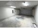 This garage has a garage door, concrete floor, and overhead lighting at 5646 Sw 129Th Place Rd, Ocala, FL 34473