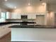 Stylish kitchen featuring granite countertops, bright white cabinets, and modern stainless steel appliances at 5646 Sw 129Th Place Rd, Ocala, FL 34473