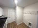 Laundry room with black countertop, utility sink hookups, and wood-look vinyl flooring at 5646 Sw 129Th Place Rd, Ocala, FL 34473