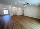 Spacious living room with hardwood floors, ceiling fan, and an abundance of natural light at 5646 Sw 129Th Place Rd, Ocala, FL 34473
