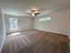 Comfortable and spacious bedroom with neutral walls, new carpet, and plenty of natural light at 5646 Sw 129Th Place Rd, Ocala, FL 34473