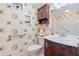 Bathroom featuring a tub and shower, vanity with a sink and storage cabinets, and decorative wallpaper at 8430 Sw 90Th Ln # A, Ocala, FL 34481