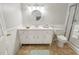 Bathroom with white vanity, round mirror, and shower at 8430 Sw 90Th Ln # A, Ocala, FL 34481
