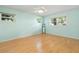 Bedroom featuring light blue walls, ceiling fan and laminate wood flooring at 8430 Sw 90Th Ln # A, Ocala, FL 34481