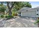 Exterior view of home showcasing driveway and lovely landscaping at 8430 Sw 90Th Ln # A, Ocala, FL 34481