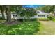 A quaint home featuring a well-manicured front yard and mature trees at 8430 Sw 90Th Ln # A, Ocala, FL 34481