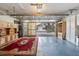 View of the garage that opens to the driveway with ample storage space and a decorative red rug at 8430 Sw 90Th Ln # A, Ocala, FL 34481