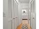 Bright hallway featuring white closet doors and a view into the bathroom at 8430 Sw 90Th Ln # A, Ocala, FL 34481