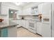 Bright kitchen featuring granite countertops, white cabinetry, and stainless steel appliances at 8430 Sw 90Th Ln # A, Ocala, FL 34481