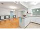 Eat-in kitchen featuring granite countertop island and updated white cabinets at 8430 Sw 90Th Ln # A, Ocala, FL 34481