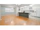 Open-concept kitchen and dining area with white appliances and hardwood flooring at 8430 Sw 90Th Ln # A, Ocala, FL 34481