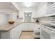 Bright kitchen featuring granite countertops, white cabinetry, and stainless steel appliances at 8430 Sw 90Th Ln # A, Ocala, FL 34481